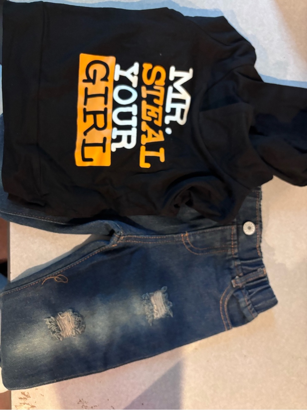 Black "Mr. Steal Your Girl" Hoodie with Orange & White Print and jeans